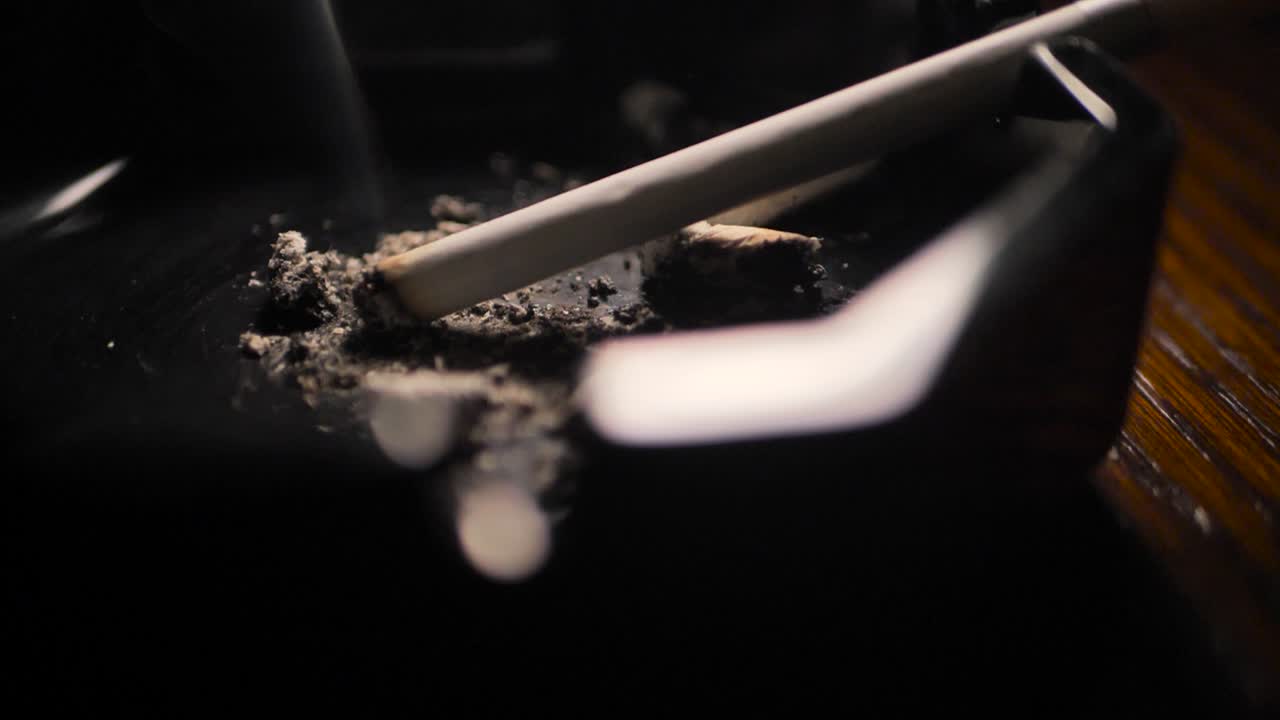 Close up smoking cigarette on man hand. Slowmotion. Scene A.