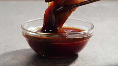 dipping gyoza in soy sauce