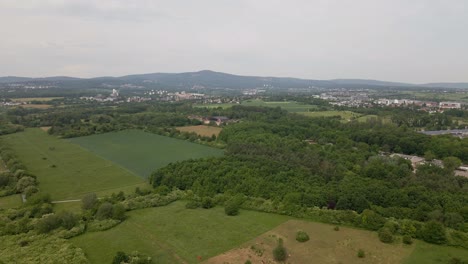 Approaching-flight-towards-an-abandoned-military-airfield-within-forests-and-fields-in-Eschborn,-Germany