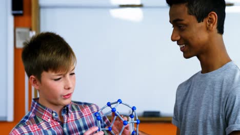 School-students-experimenting-molecule-model-in-laboratory