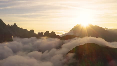 golden sunrise silhouetted south tyrol tre cime mountains surrounded by heavenly clouds aerial rising view