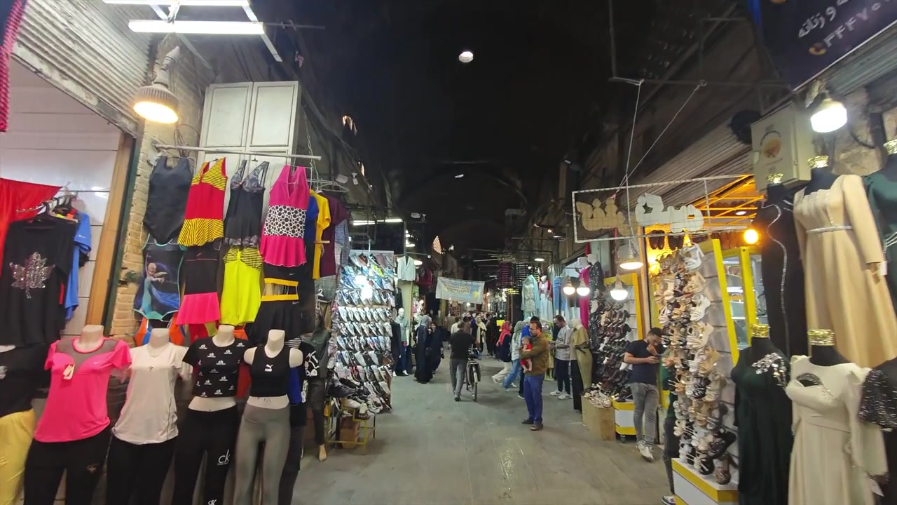 Crowded Traditional Bazaar Alleyway with Clothing Shops and Mannequins
