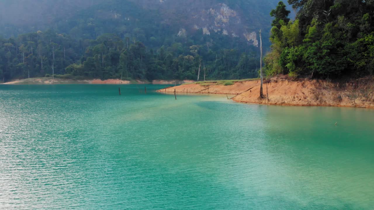 Tayland, Khao Sok Milli Parkı'nda zümrüt yeşili suya sahip sakin göl ve yeşil ormanın güzel manzarası