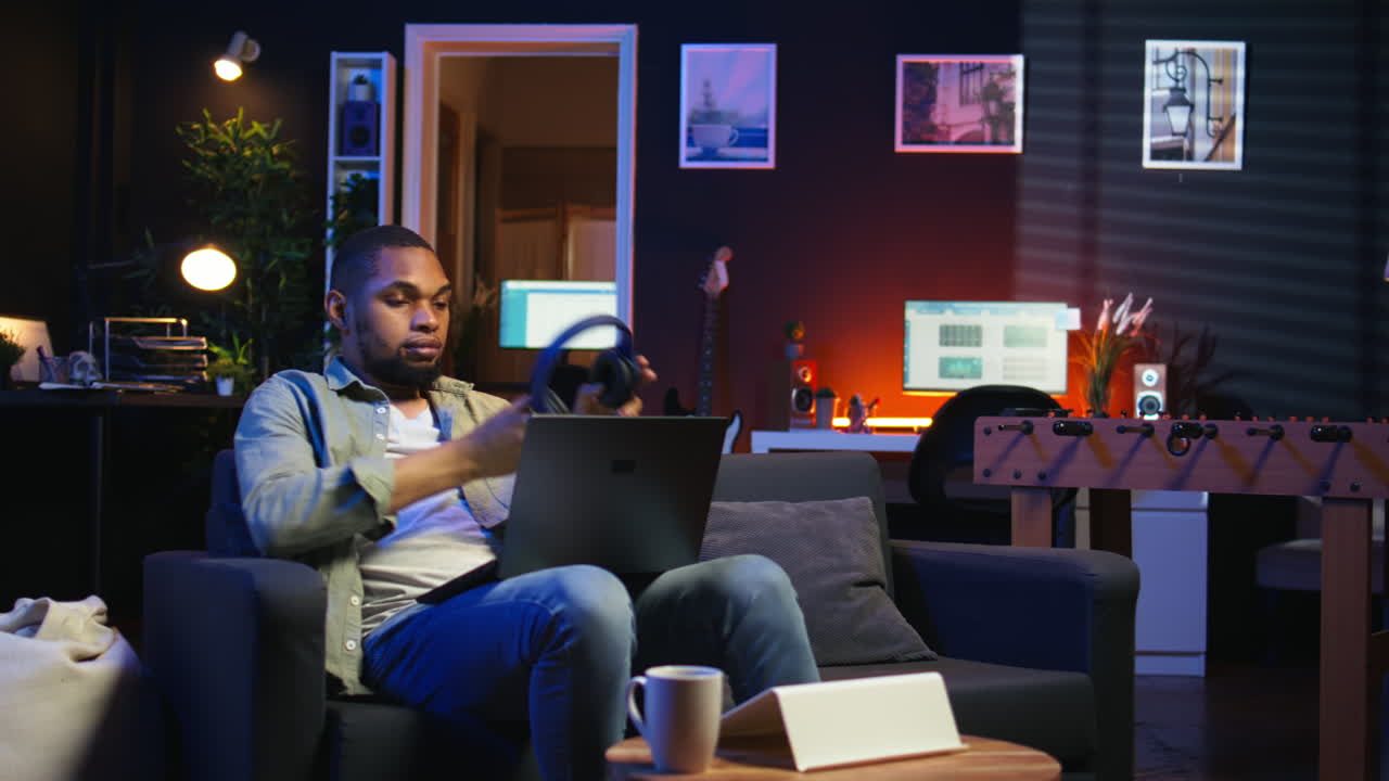 Vertical Video African american person attending a webinar on wireless pc in his living room
