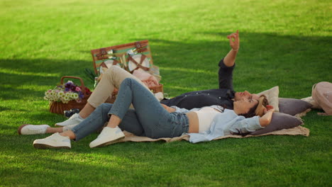 cheerful couple staring at sky in park