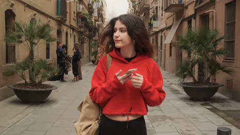 young girl using smartphone while walking in the street