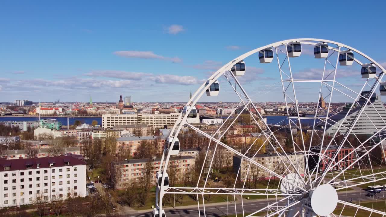 Ferris Wheel In Pardaugava With Riga Skyline In The Background In Latvia. - aerial shot
