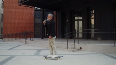 older man skateboarding in the city