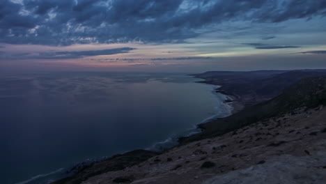 calm sea at sunset along agadir coastline and cloudscape, morocco