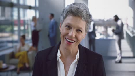 Businesswoman-looking-at-camera-in-the-lobby-at-office-4k