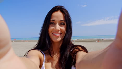 Brunette-Woman-Taking-Self-Portrait-on-Beach