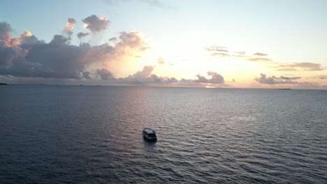 boat at sunset in the indian ocean maldives travel holiday destination paradise aerial footage