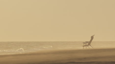 empty beach chair on a misty day