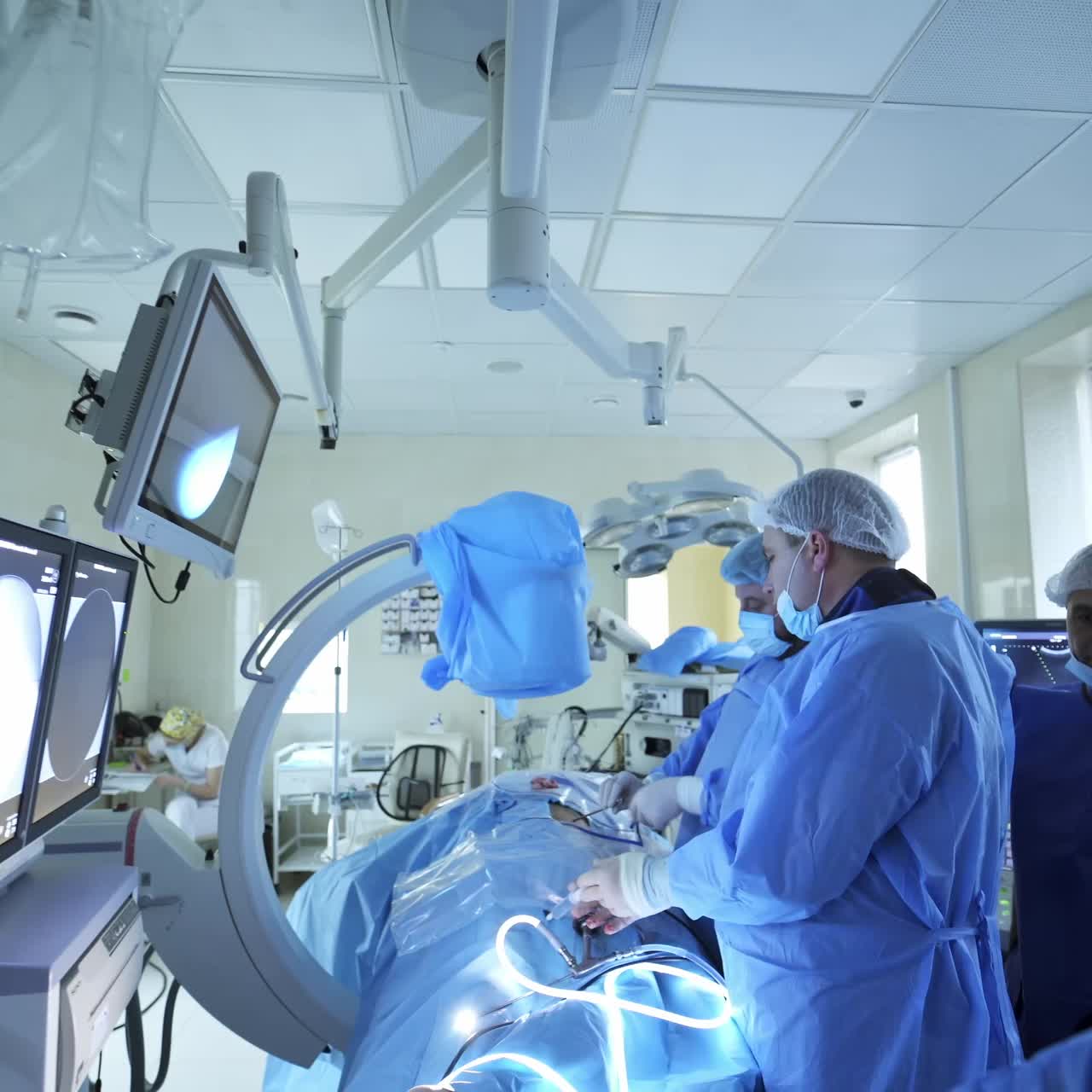 Surgery with laparoscopic equipment. Surgeons team performing gynecology laparoscopy surgery in operating room