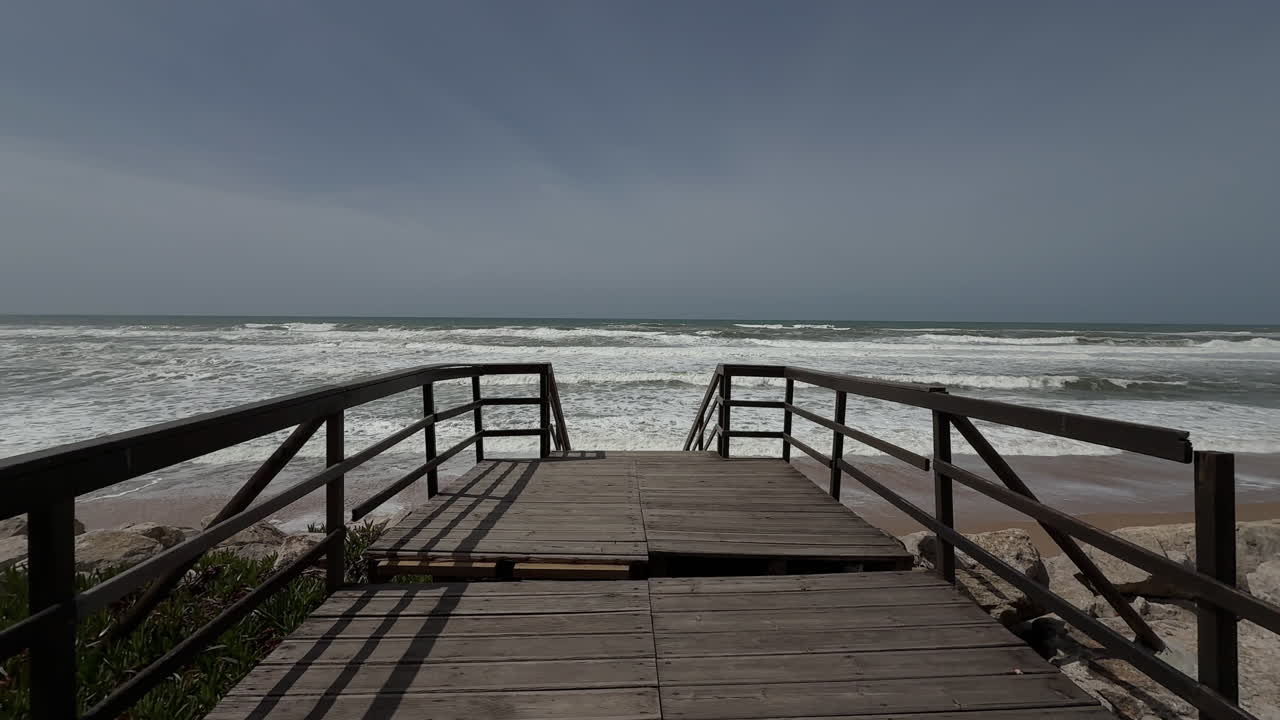 Waves at Praia Grande in the afternoon from the boardwalk