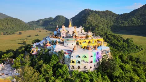 brightly colored temple on top of the hill