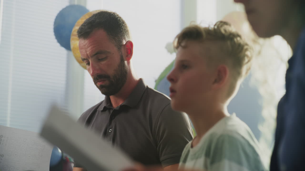 Parents Looking at School Exam Grades of Their Son Upset About Poor School Performance