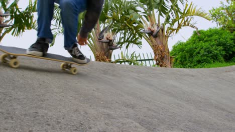 Low-angle-view-of-young-caucasian-man-practicing-skateboarding-on-ramp-in-skateboard-park-4k