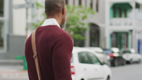 african american man walking in the street with his bike