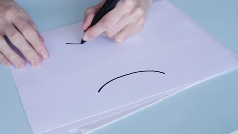 person illustrating on white paper the gemini zodiac sign