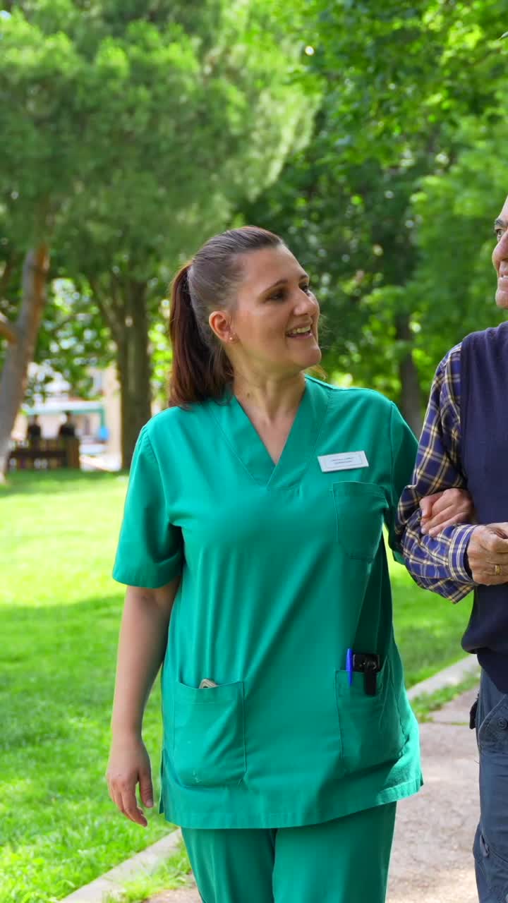 Caregiver assisting elderly man outdoors