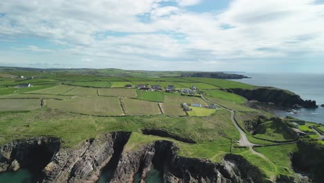 Rural-coastal-region-in-West-Cork,-Galley-Head-peninsula,-Ireland-on-a-sunny-day-with-doted-villages-and-rugged-coast