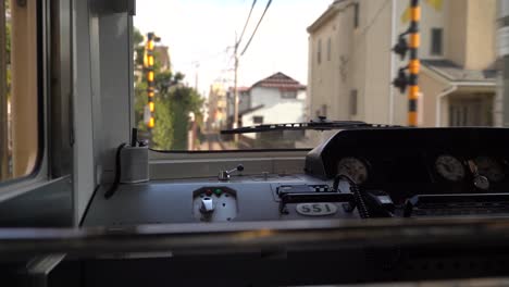 view inside train driving through japanese town passing by enoshima dentetsu railway in japan - static shot