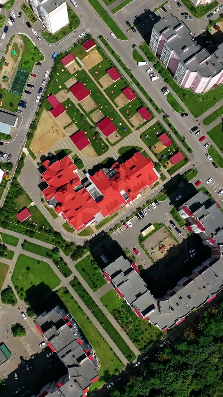 Drone view of city building block. Top down view of new modern block of flats in green area