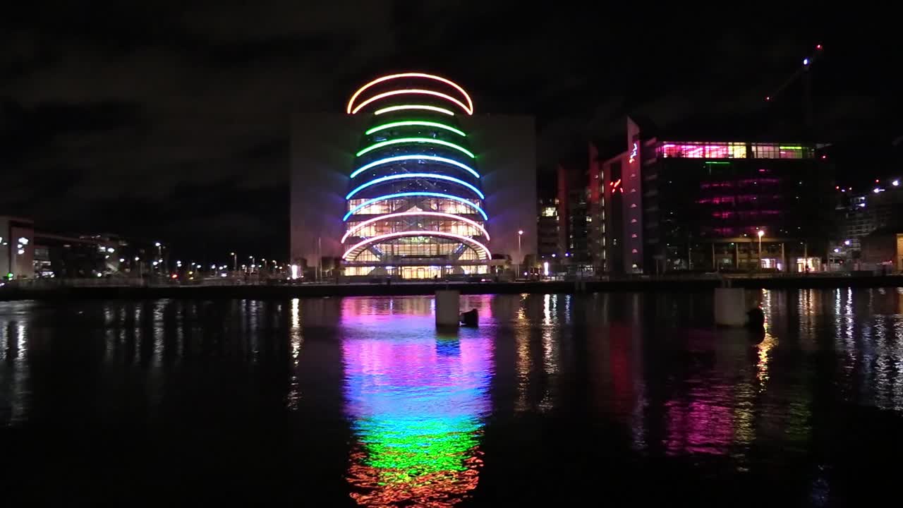 차량과 구름이 지나가는 더블린 컨벤션 센터의 스틸 샷과 야간 시간