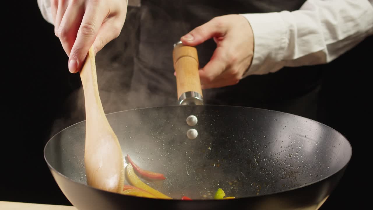 Chef Stir-frying Peppers in Wok