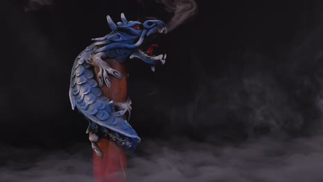 dragón largo chino en una habitación llena de humo exhalando humos en un poste mientras gira lentamente