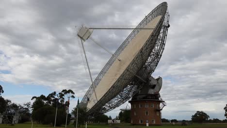 time-lapse of a satellite dish rotating under cloudy sky