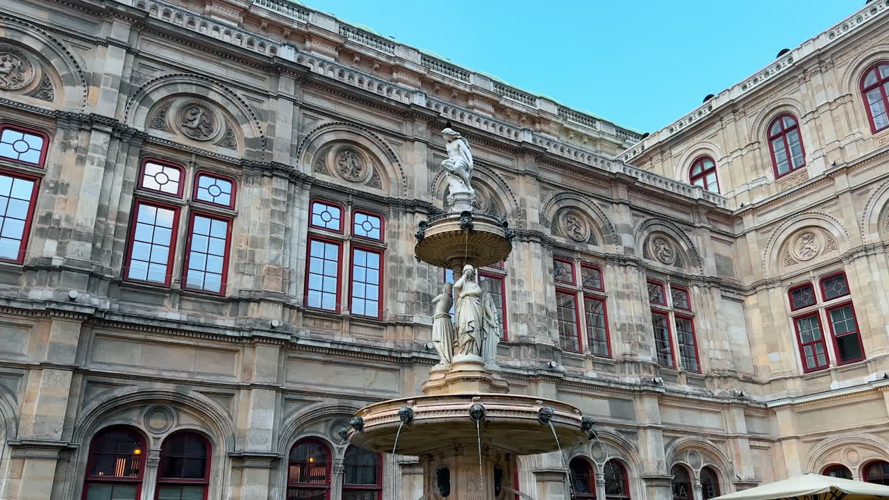 Vienna, Austria - June 9, 2025: Close look at the beautiful fountain in front of Vienna State Opera. Low angle view at the architectural masterpiece of Austria