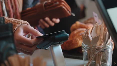 close-up-customer-paying-using-credit-card-contactless-payment-spending-money-in-cafe-with-digital-transaction-service