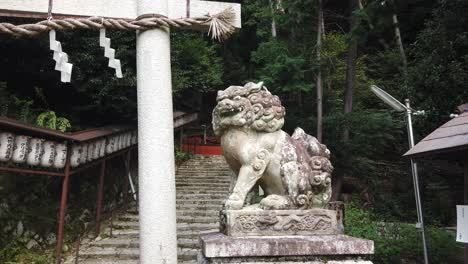 lion animal temple guardian sculpture in kyoto japan, shinto shrine entrance door, stairs and stone path, japanese religon