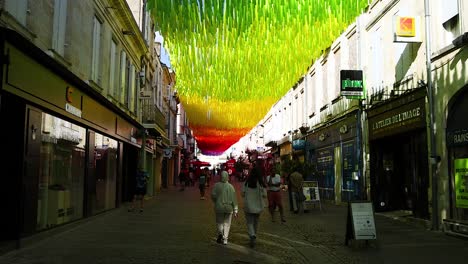 vibrant canopy adorns a bustling french street