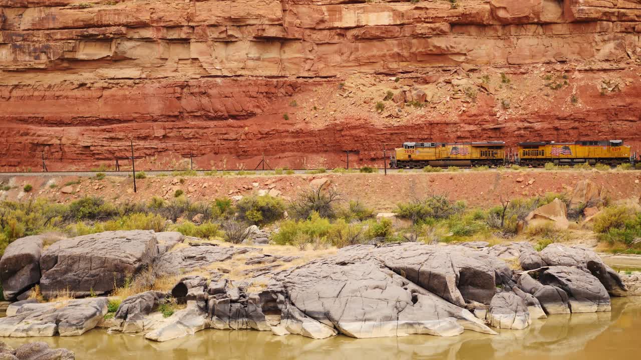 Freight train passes above Colorado River in Black Canyon