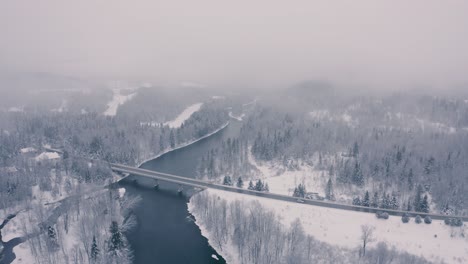 Foggy-Winter-Landscape---Drone-Flying-4K---Mountains---Trees,-rivers,-snowy---Cinematic-bridge