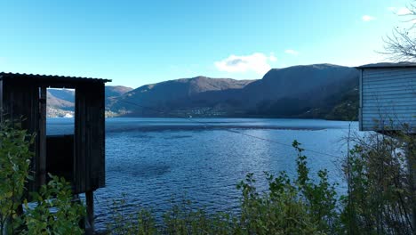 two historic salmon fishing huts at stavenes with view towards vaksdal, norway