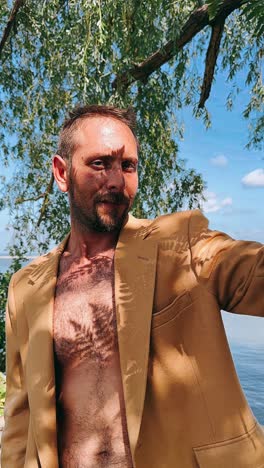 man in a jacket under tree shade