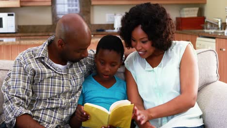family reading a book in living room 4k