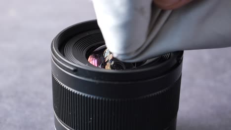 cleaning a camera lens with a microfiber cloth