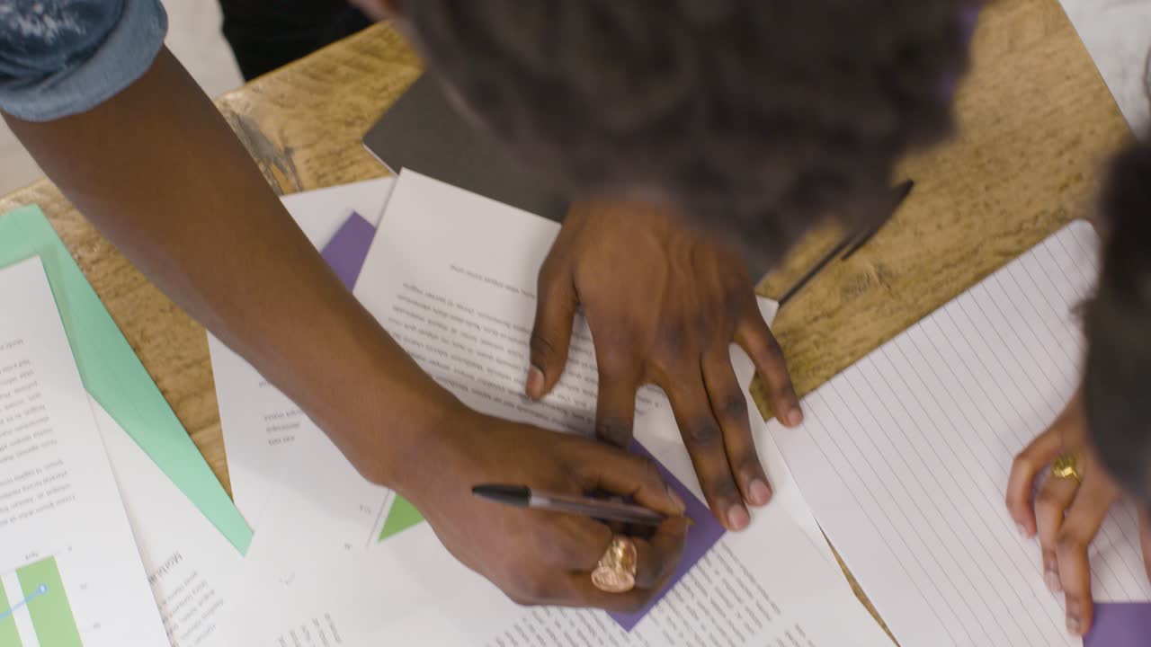 Overhead Of Paperwork And Business Colleagues Brainstorming Together At Table