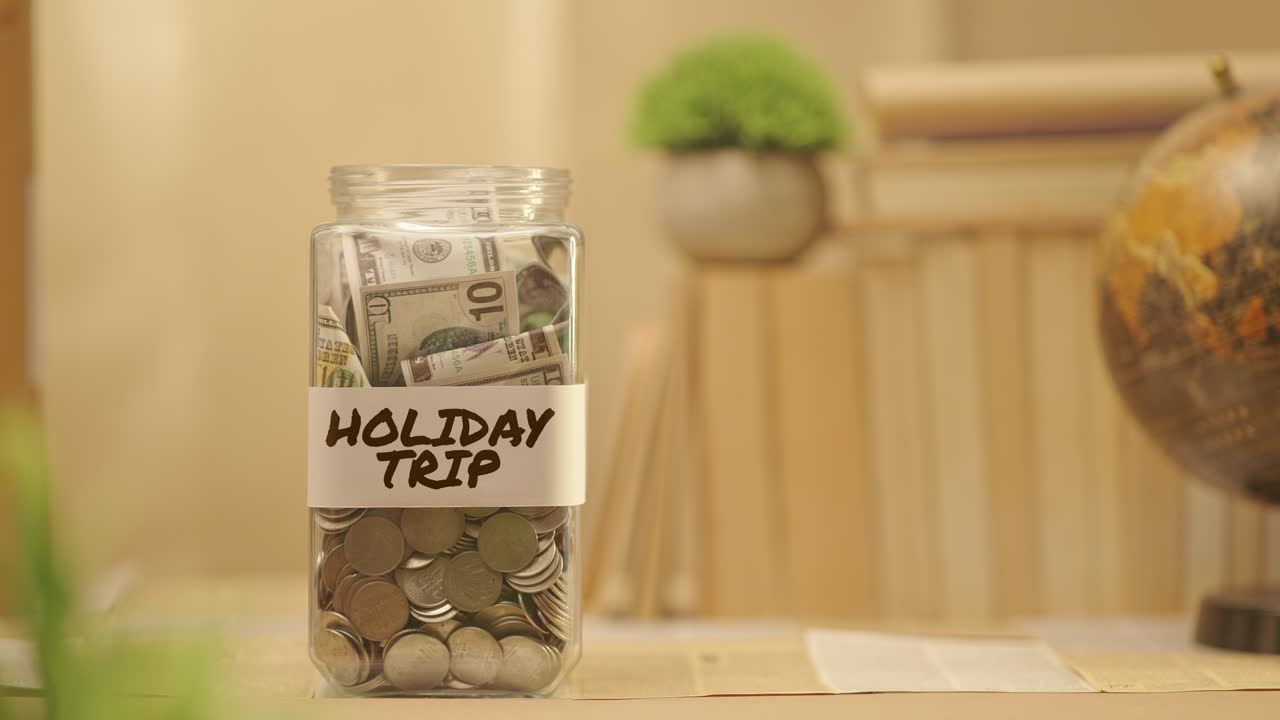 PERSON SAVING MONEY FOR HOLIDAY TRIP