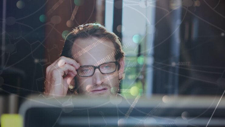 Animation of dna rotating over caucasian man working with computer in office