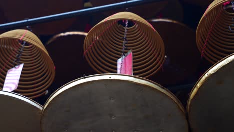 cone incense burning with smoke in tin hau temple, hong kong