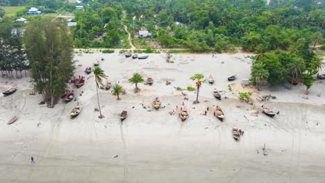 Fishing-Boat-Canoes-at-Shoreline-Of-Kaukata-Sea-Beach,-Bangladesh,-South-Asia