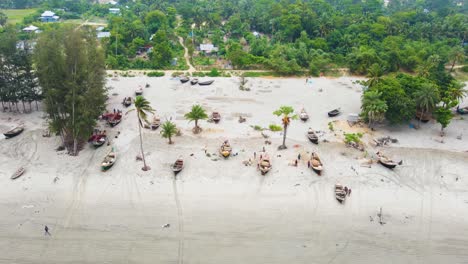 fishing boat canoes at shoreline of kaukata sea beach, bangladesh, south asia