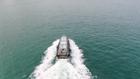 aerial footage of a service ship cruising in hong kong bay