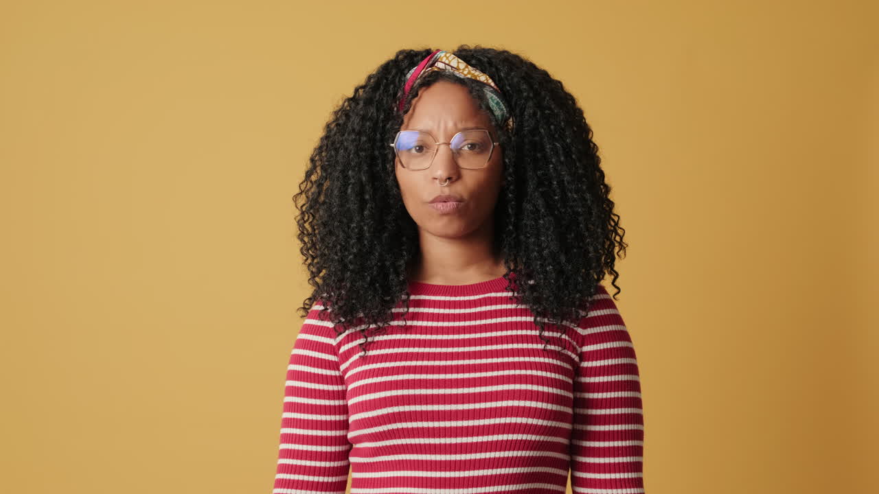 Young African American Woman with Curly Hair Expressing Doubt